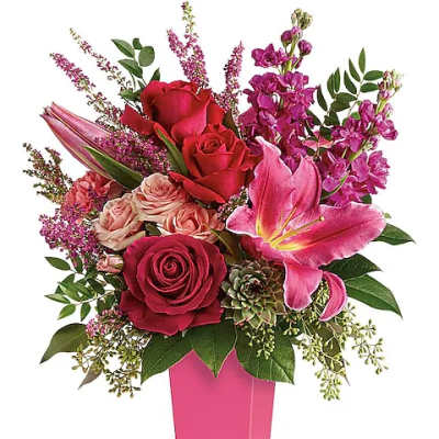 Pink and red rose bouquet in a tall pink vase
