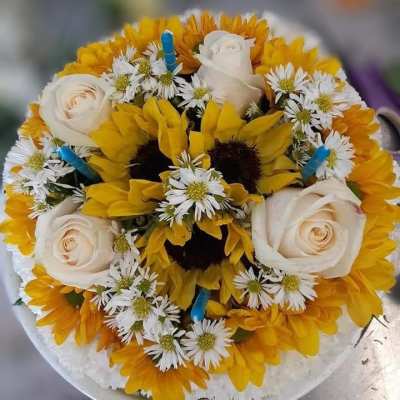 Round bouquet of yellow sunflowers, white roses, and small white daisies
