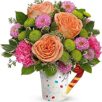 Peach roses and pink pompom flowers in a confetti-patterned cup