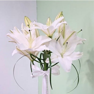 White lily bouquet tied with a white ribbon