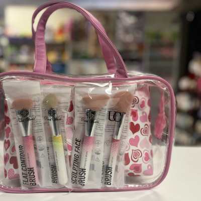 Pink cosmetic bag with four makeup brushes inside
