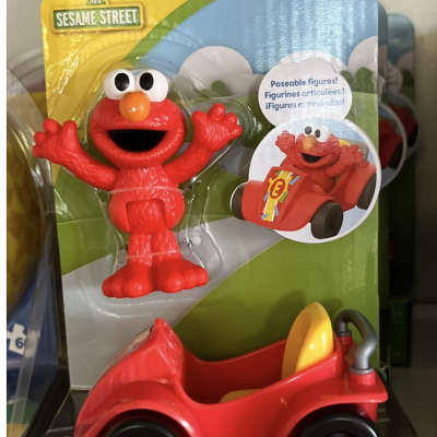 Elmo figurine with a red kart in Sesame Street packaging