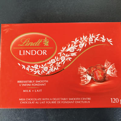 Red Lindt Lindor chocolate box on a dark surface