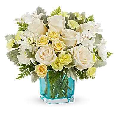 White roses and daisies arranged in a blue glass vase