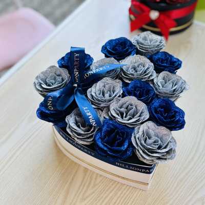 Box of glittery blue and silver roses tied with a ribbon