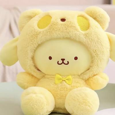Yellow plush bear wearing a hood and bow tie