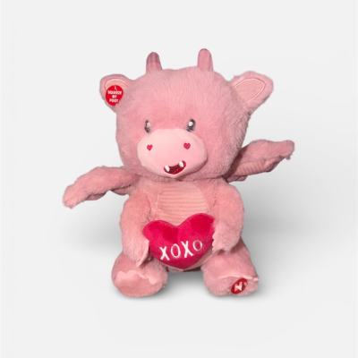 Pink plush pig holding a heart with "XOXO"