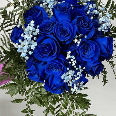 Bouquet of vivid blue roses with light blue baby's breath
