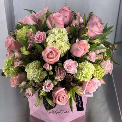 Pink roses and green hydrangeas in a pink wrap