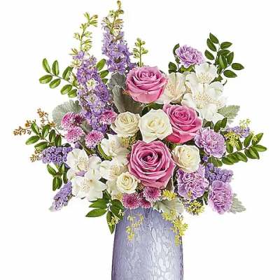 Pink and white roses with purple flowers in a lavender vase