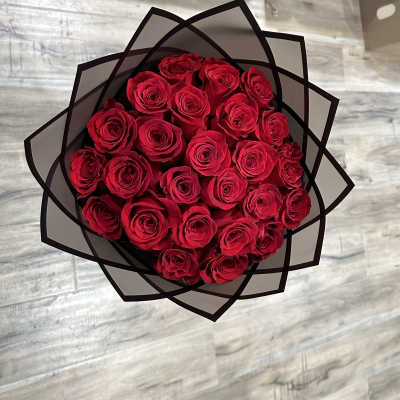 Bouquet of red roses wrapped in black paper