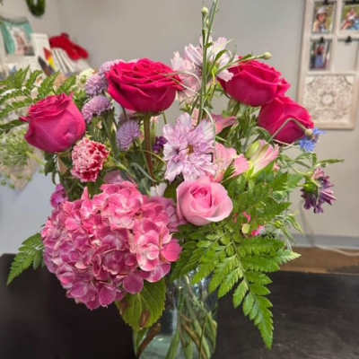 Pink roses and hydrangea arranged in a glass vase