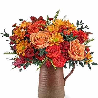 Autumn bouquet of orange roses and yellow daisies in a brown pitcher