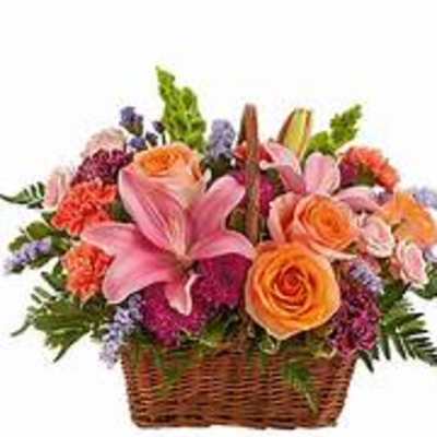 Basket of pink lilies, orange roses, and mixed flowers