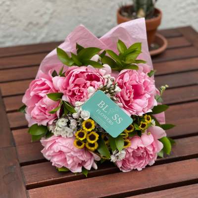 Pink peony bouquet with small white and yellow filler flowers