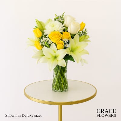 Yellow and white bouquet in a clear glass vase