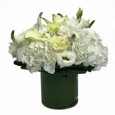 White floral arrangement in a dark green vase
