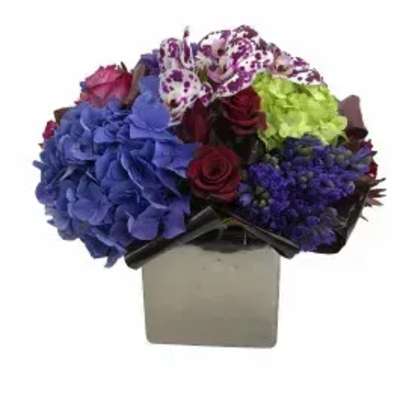 Bouquet of blue hydrangeas, roses, and orchids in a square vase
