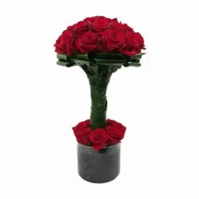Red rose arrangement in a black cylindrical vase