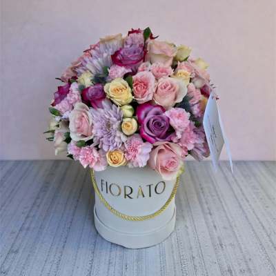 Pink and lavender rose bouquet in a white hat box