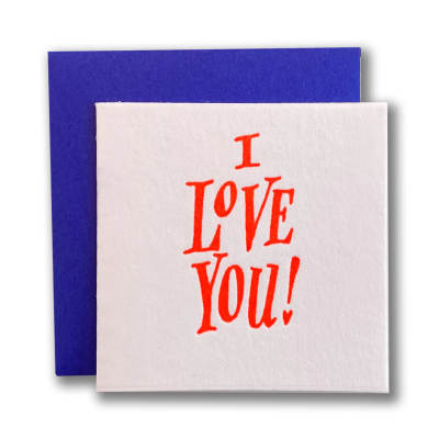 White card with red I Love You text layered over a royal blue envelope
