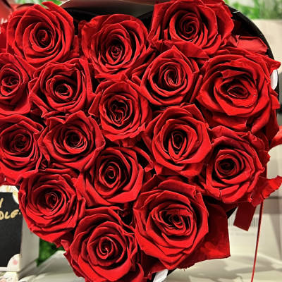 Bouquet of red roses wrapped in black paper