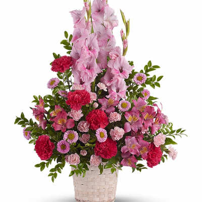 Pink gladiolus and mixed pink flowers in a woven basket