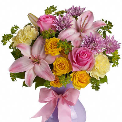 Pink and yellow mixed bouquet in a lavender vase with a pink ribbon