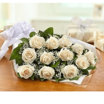 Bouquet of cream roses with baby's breath wrapped in white paper