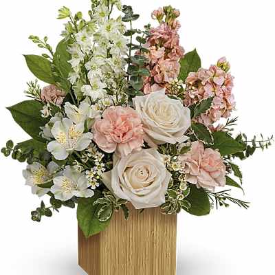 Pink and white flower arrangement in a wooden cube vase