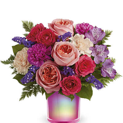 Bouquet of pink and purple flowers in a pink iridescent vase