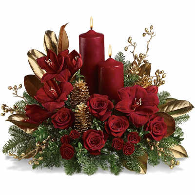 Red roses and amaryllis arranged with two burgundy candles