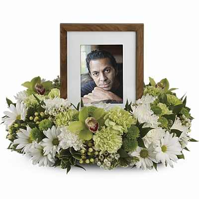 Framed photo surrounded by white and green flowers