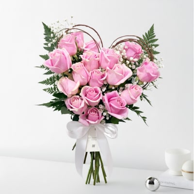 Bouquet of pink roses with baby's breath and a white ribbon