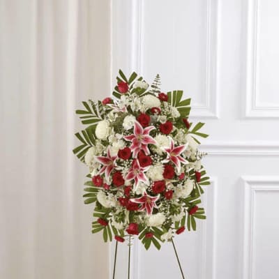 Standing floral spray with red and white flowers on an easel