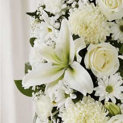 White floral bouquet with lilies, roses, and daisies