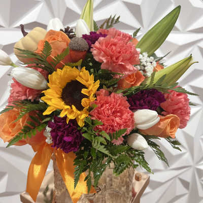 Colorful bouquet with sunflowers, carnations, roses, and tulips