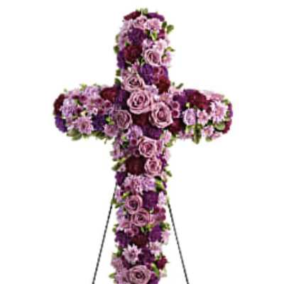 Purple and pink floral cross on a metal stand