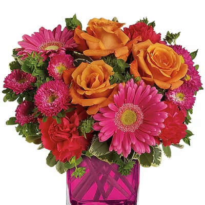 Bouquet of orange roses and pink daisies in a magenta glass vase