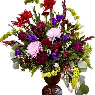 Mixed bouquet in a dark urn vase with red, purple, pink, and green blooms