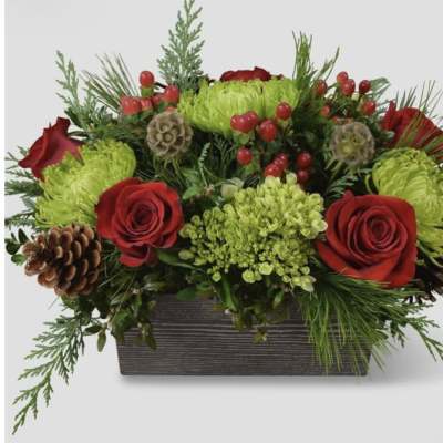 Red roses and green chrysanthemums in a rectangular planter with pinecones