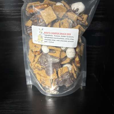 Clear bag of camper snack mix with pretzels, cereal, marshmallows, and chocolate pieces