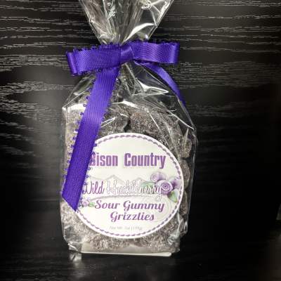 Bag of sour gummy grizzlies tied with a purple ribbon