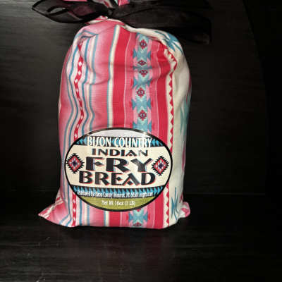 Bag of Indian fry bread mix tied with a black ribbon