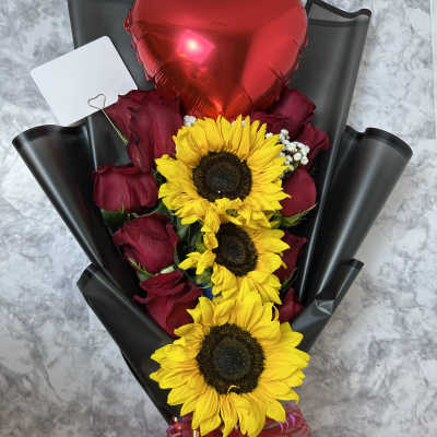 Bouquet of red roses and sunflowers with a red heart balloon