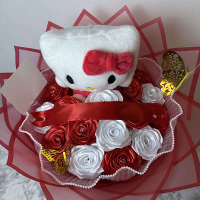 Hello Kitty plush in a bouquet of red and white satin roses