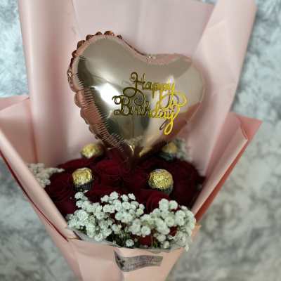 Red rose bouquet with a heart-shaped birthday balloon