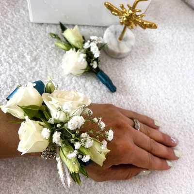 White rose wrist corsage with baby's breath and ribbon