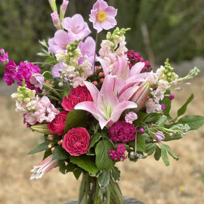 Pink mixed bouquet with lilies and roses in a glass vase