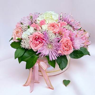 Pink and white bouquet in a round box with a ribbon